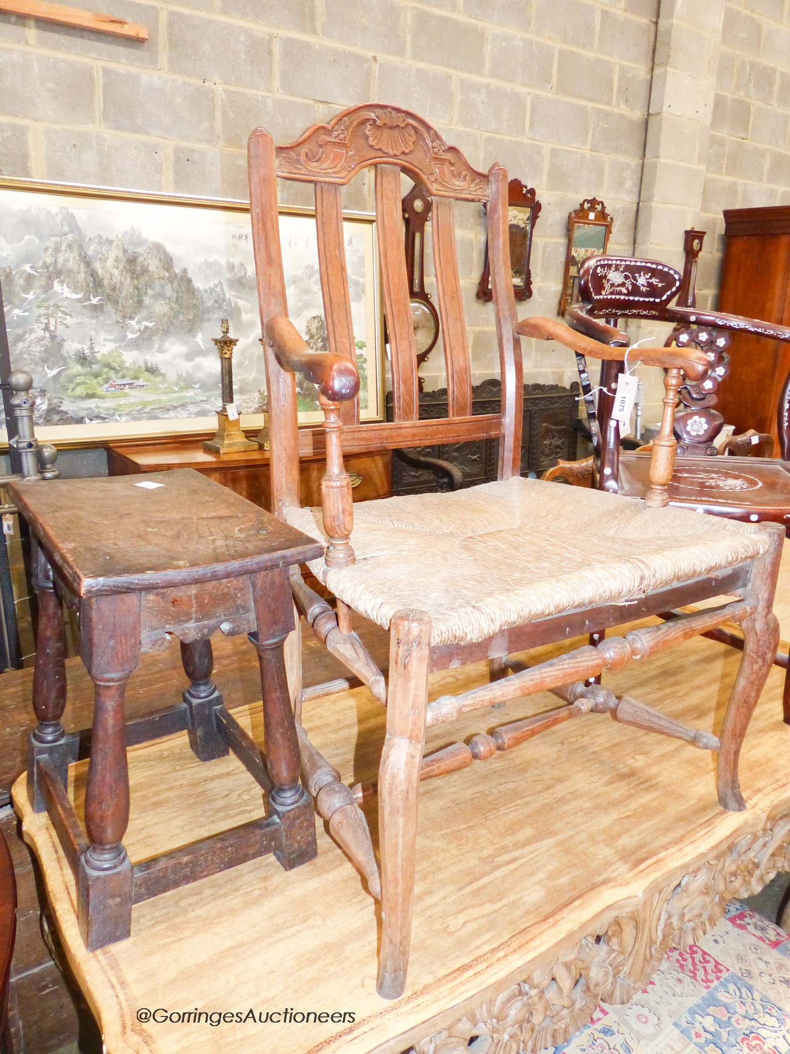 An early 18th century oak rectangular topped stool and an oak lathe back elbow chair (2)